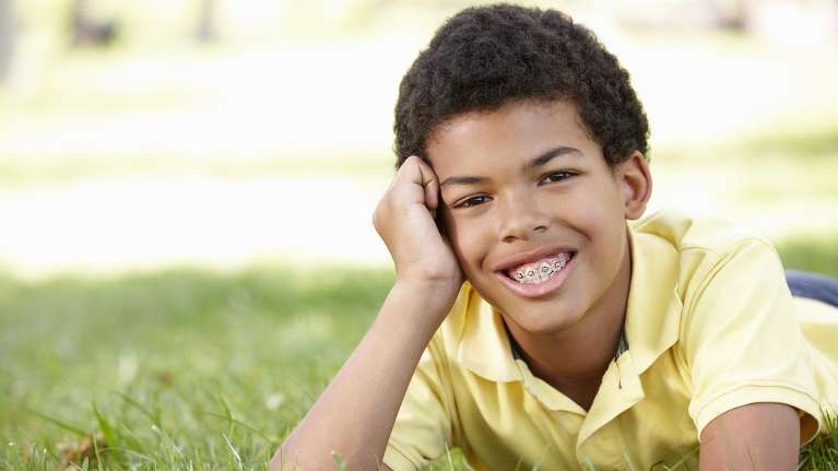 A young kid with braces from Decatur's Top Pediatric Dentist