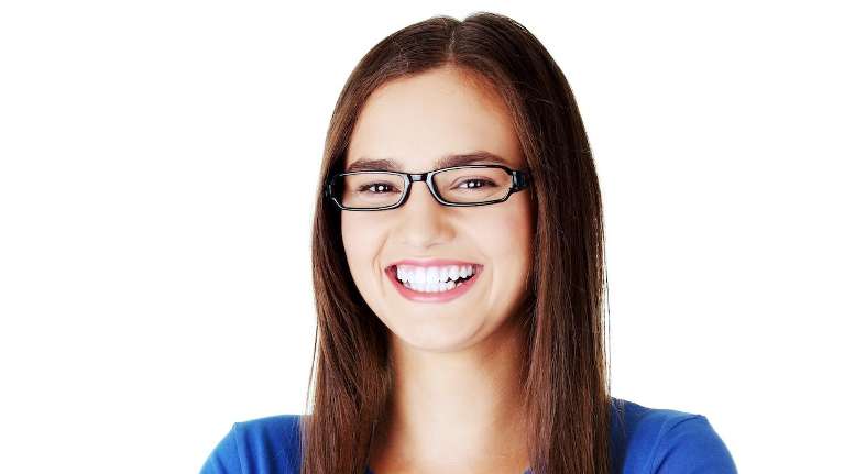 Patient smiling after getting clear braces in Decatur, IL