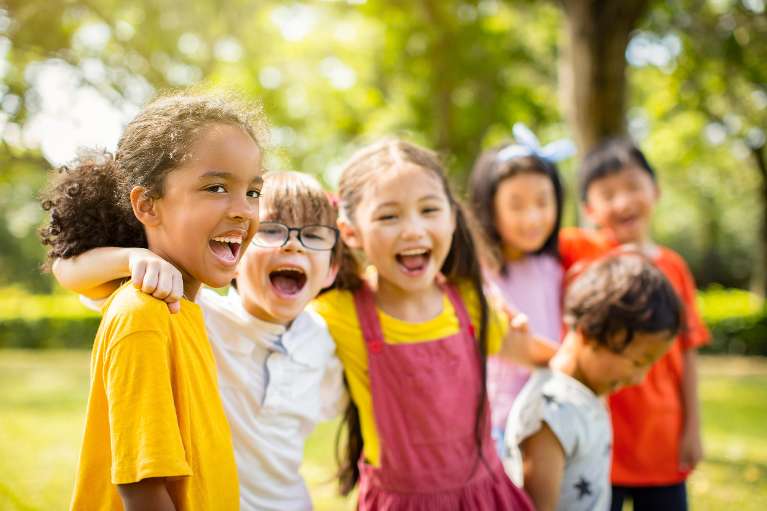 A group of children smiling after visiting a dentist in Decatur, IL 