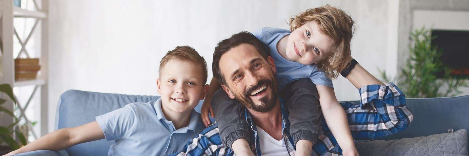 A Father and his children smiling after Orthodontic treatment in Decatur, IL